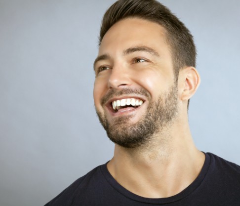 Man with flawless smile after metal free dental restoration