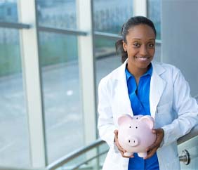 emergency dentist in Mankato holding a pink piggy bank