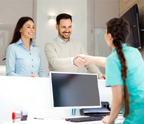 dental team member shaking a patient’s hand