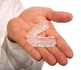 person holding a mouthguard