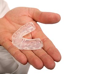 closeup of person holding a mouthguard