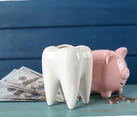 tooth and piggy bank for cost of dental implants in Mankato           