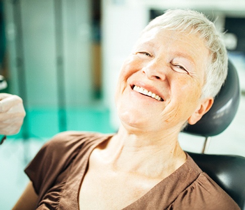 happy woman at dentist for dental implants in Mankato