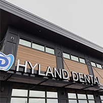 Two team members and patient smiling in the dental office