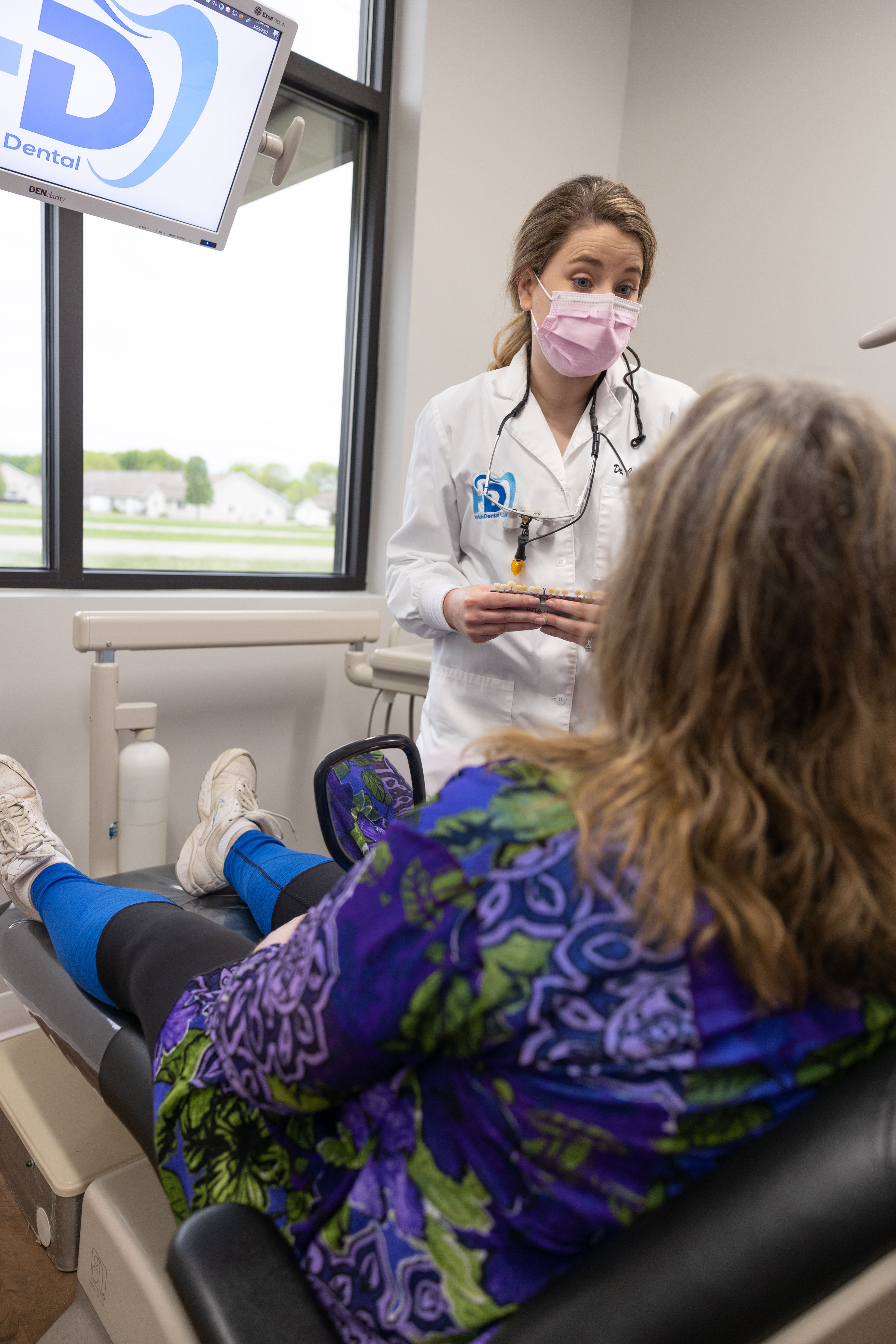 Dental team member and patient discussing what dental insurance covers