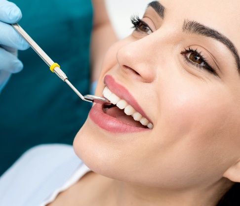 Woman receiving oral cancer screening