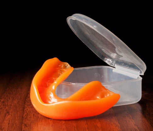 Orange athletic mouthguard and carrying case