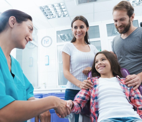 Parents and child in dental office for children's dentistry visit