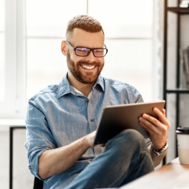 Man sending an email to request a dental appointment