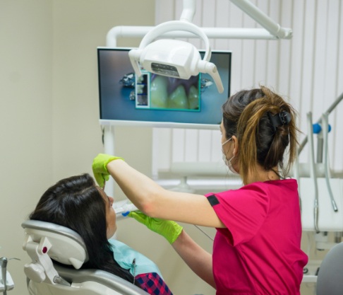 Dental team member using intraoral camera to capture smile images