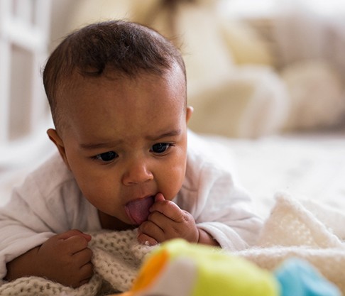 A baby struggling with a tongue-tie