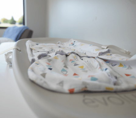 A mother with her baby asleep on her chest