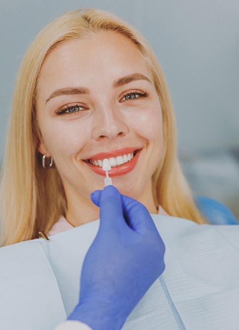 a patient smiling during a cosmetic dentistry appointment 