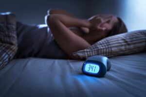 Person suffering during sleepless night.